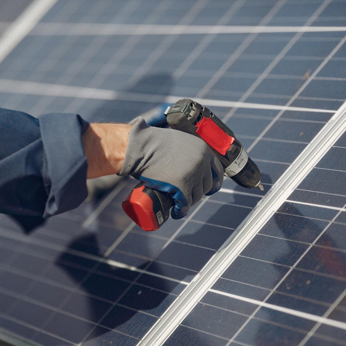 man-with-white-helmet-near-solar-panel.jpg